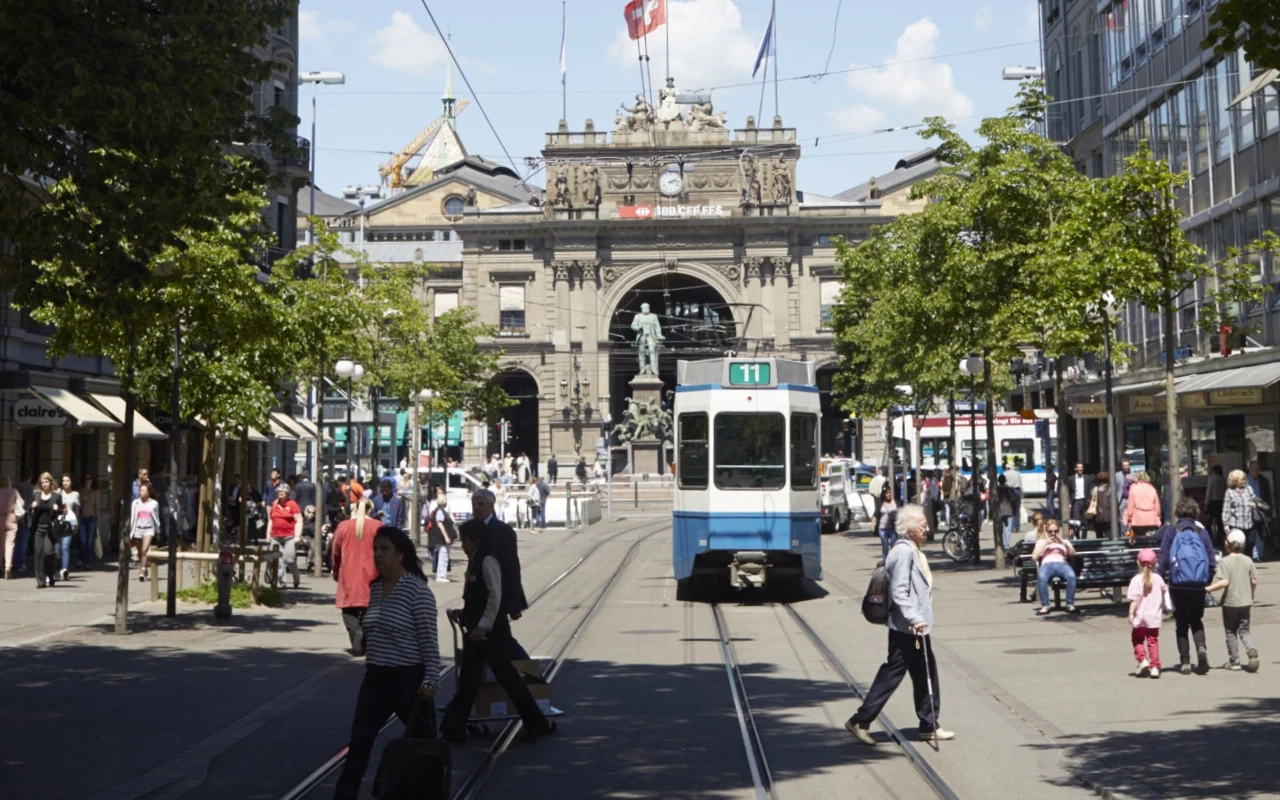 View from Bahnhofstrasse to the Main station, Tram 11 to Convention Center approaching